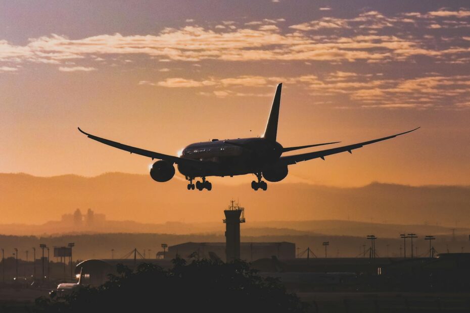 Airplane in the sunset sky